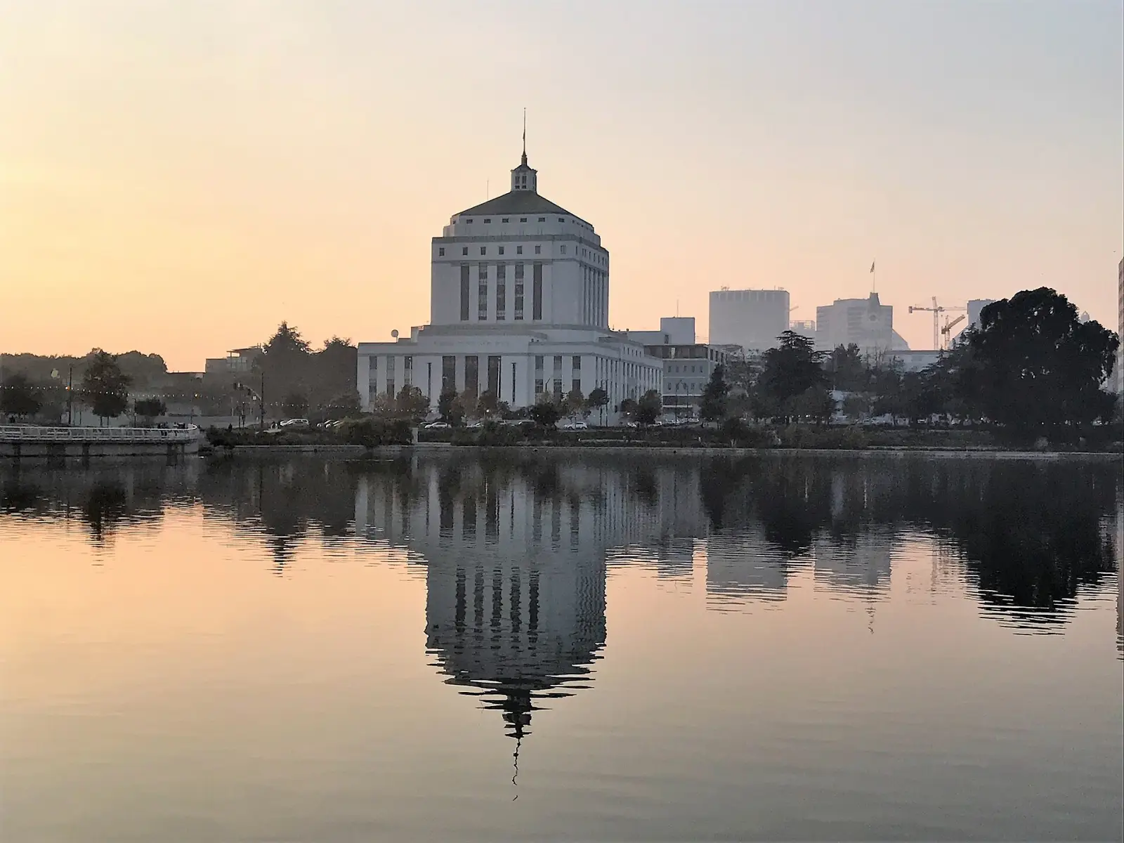 The Alameda County Courthouse reflected in Lake Merritt at sunset